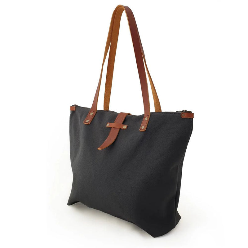 Hand cut and handcrafted using strong, durable 100% cotton canvas, coated with a natural beeswax making it water resistant. 