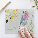 Experience the seamless blend of functionality and artistry with the Indigo Birds, Fynbos and Lilac-breasted Roller Mousepad, featuring birds in flight painted with indigo watercolour.