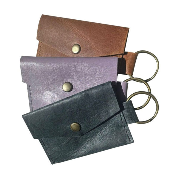 Small, but packs a big punch!

Card and coin leather keychain pouch.

9cm x 6cm with a 2.5cm ring
Made from full grain bovine leather
Small brass press stud and brass ring
Available in black, denim diesel, lilac & toffee. Other leather colours available on request.