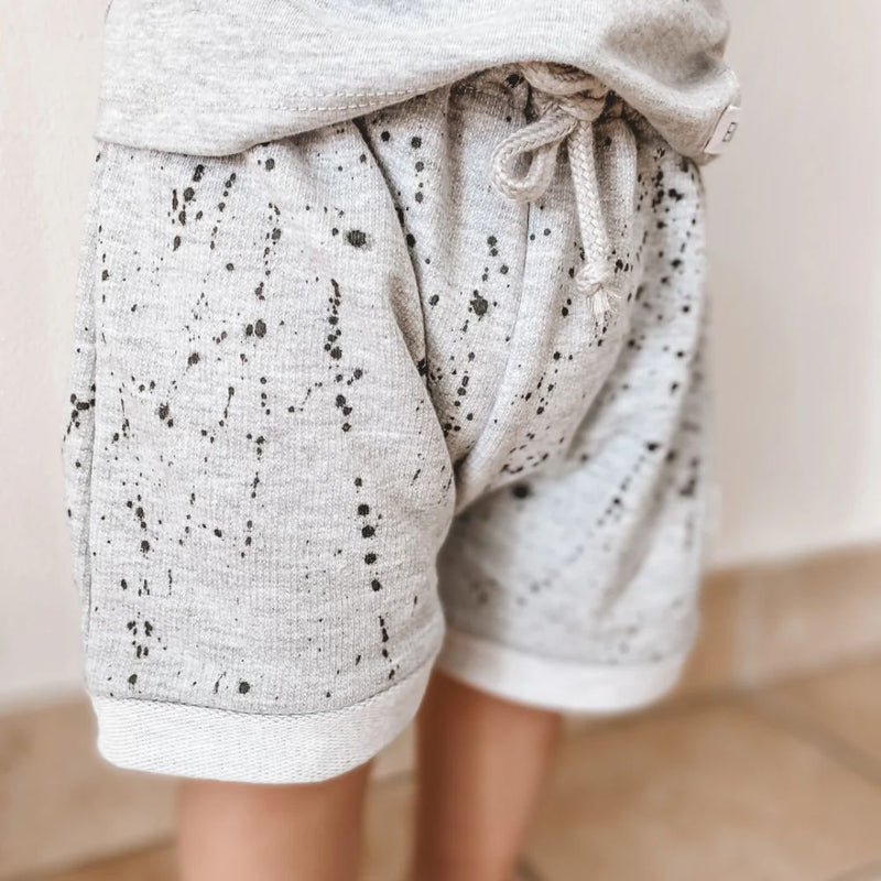 Cool, light and perfect for spring, summer and play time!

Made in 100% Cotton fabric.

Single printed cool kid T-shirt | Unbrushed Fleece Shorts with splatter ink print and string detail. 

