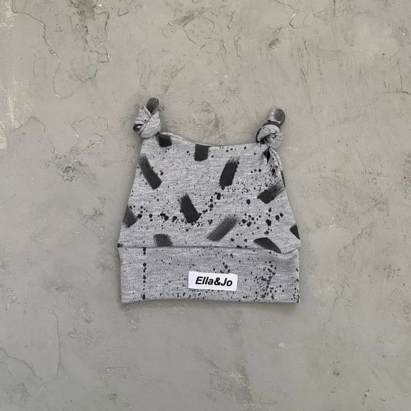 Designed especially for the cool kid

Double Knot Style Beanie made with soft 100% Cotton Interlock.

Grey Melange with Blank ink Brushstroke and Splatter detail.