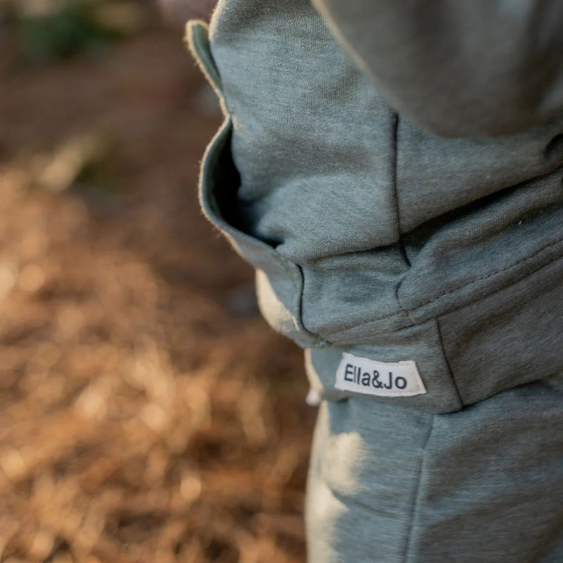 The Khaki Bear Tracksuit is not just an ordinary one. It has been designed with comfort, style and play time in mind. Front pocket has bear face detail, and the legs has soft cushion openings which provides extra cushioning when little one is crawling or sitting.

Colour - Khaki Melange