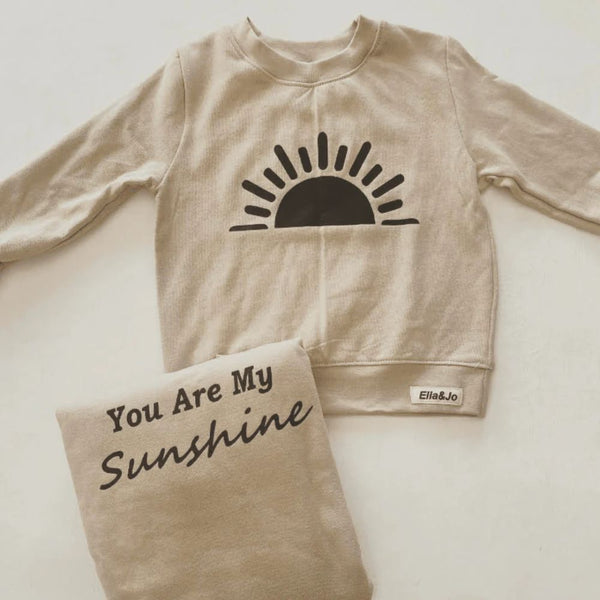 Our Sunshine Duo set has everything you need with the Matchy Look and comfort.
Round crew Neck, Rib Cuff and Waistband.
Relaxed Fit.
Stone with white print. Sunshine print on baby/toddler sweater and Mom's sweater says You are my Sunshine.
100% Cotton Brushed Fleece