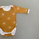 Long Sleeve onesie with envelope neck
Snaps at crotch to assist with easy diaper changes.
100% Cotton Interlock

Design - Rusty Sun


