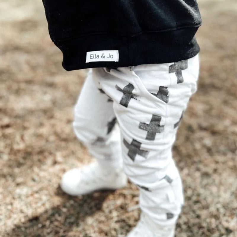 Front Pocket Detail, Elastic Waist. The Bottom of joggers is cuffed.
100% Cotton Brushed fleece
White Jogger with Black Crosses, Caramel with Black Splatter, Plain Black.