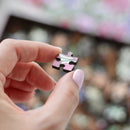 Each puzzle comes in a bespoke, gold-foiled burgundy box, custom-made to close seamlessly and hold lid and base tight together so that you can store your puzzle on display alongside your books on your bookshelf.