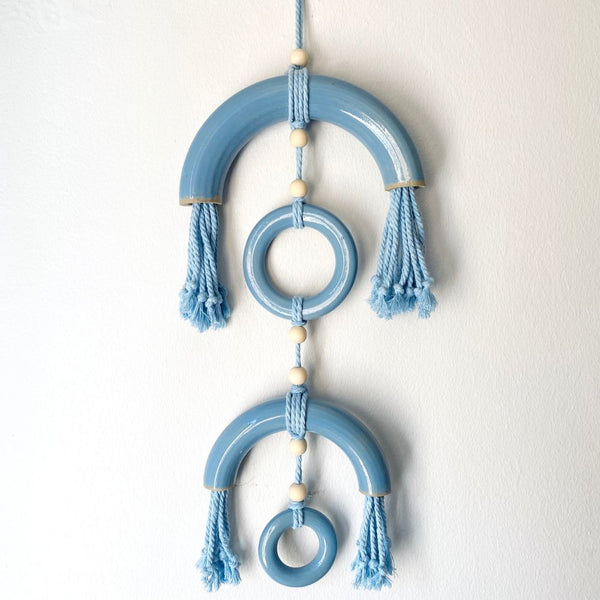 Reverberations are handcrafted wall-hanging art pieces combining textured stoneware and soft fibre elements.