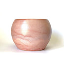 Handmade ceramic flower pot in a soft pink glaze, perfect for showcasing indoor plants or succulents. This artisanal planter adds a touch of warmth and charm to your home décor while providing a stylish and durable home for your greenery.