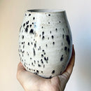 An oval stoneware vase adorned with speckled appaloosa glaze – reminiscent of the wild horses with the same distinctive coats.