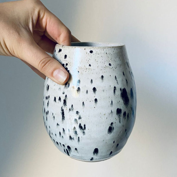 An oval stoneware vase adorned with speckled appaloosa glaze – reminiscent of the wild horses with the same distinctive coats.