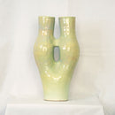 A Tall coil build stoneware vase extending into two necks covered with a melon green glaze.