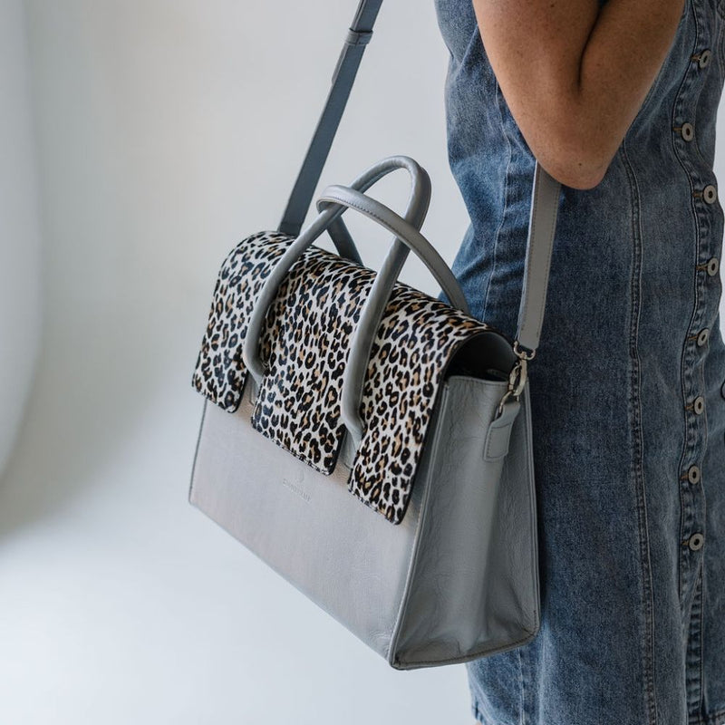 Introducing the&nbsp;Exotic Nguni Bossbag, a work bag designed for women by women. Crafted from&nbsp;rich brown leather&nbsp;and featuring an&nbsp;exotic Nguni hair-on leather finish&nbsp;with a stunning blue metallic element, this bag is both stylish and functional.