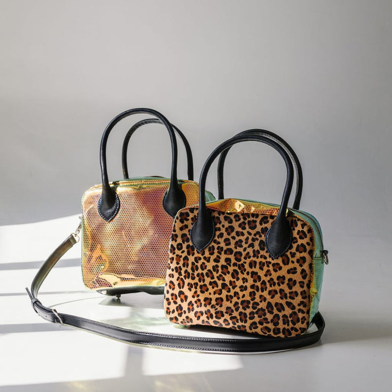 A limited-edition bag with only 10 pieces made. This exclusive design features exotic Nguni hair-on leather with delicate metallic gold splashes, beautifully complemented by a caramel leather back, bottom and sides.