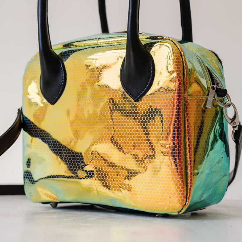 A limited-edition bag with only 10 pieces made. This exclusive design features exotic Nguni hair-on leather with delicate metallic gold splashes, beautifully complemented by a caramel leather back, bottom and sides.