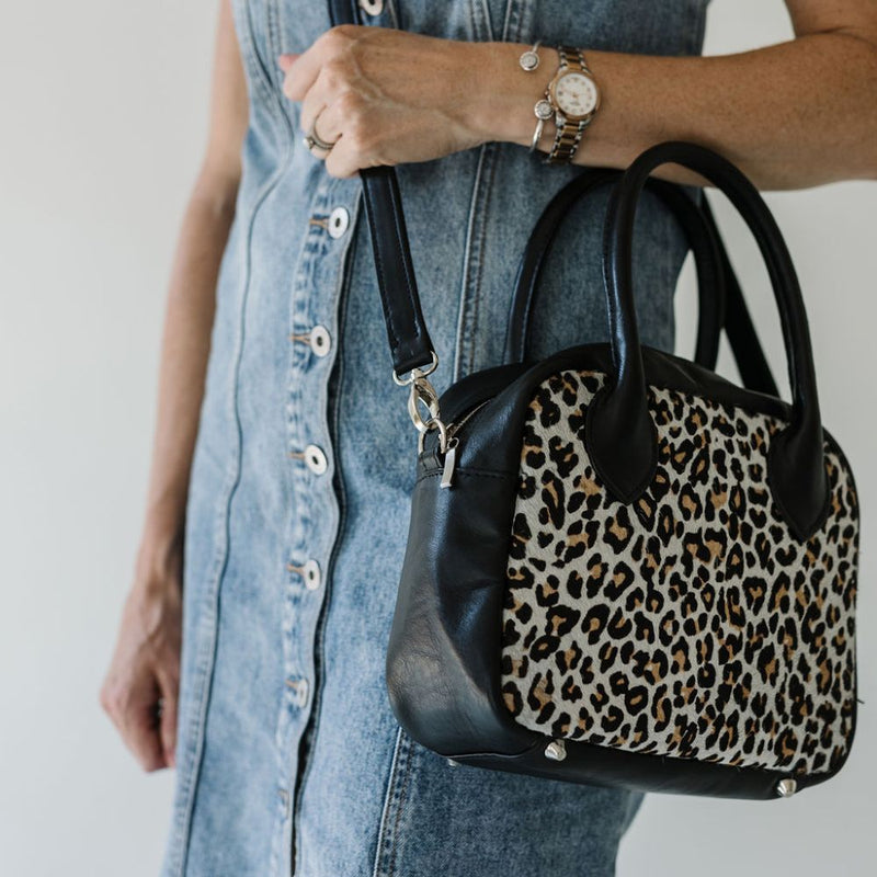 A limited-edition bag with only 10 pieces made. This exclusive design features exotic Nguni hair-on leather with delicate metallic gold splashes, beautifully complemented by a caramel leather back, bottom and sides.