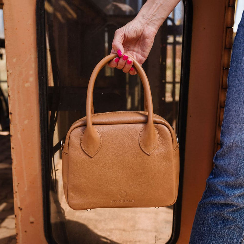 A limited-edition bag with only 10 pieces made. This exclusive design features exotic Nguni hair-on leather with delicate metallic gold splashes, beautifully complemented by a caramel leather back, bottom and sides.