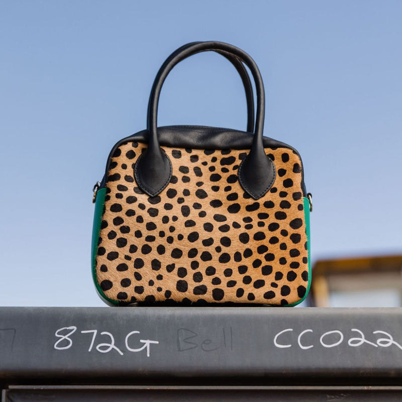 A limited-edition bag with only 10 pieces made. This exclusive design features exotic Nguni hair-on leather with delicate metallic gold splashes, beautifully complemented by a caramel leather back, bottom and sides.