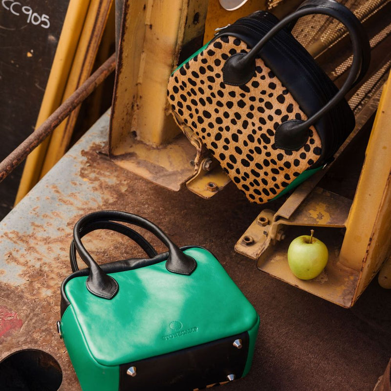 A limited-edition bag with only 10 pieces made. This exclusive design features exotic Nguni hair-on leather with delicate metallic gold splashes, beautifully complemented by a caramel leather back, bottom and sides.