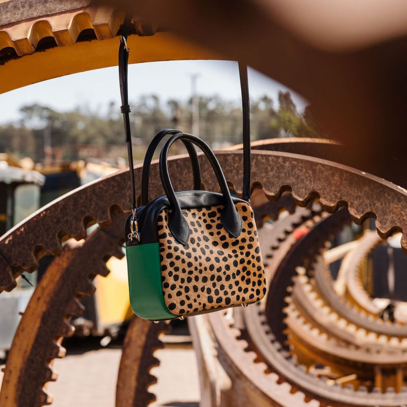 A limited-edition bag with only 10 pieces made. This exclusive design features exotic Nguni hair-on leather with delicate metallic gold splashes, beautifully complemented by a caramel leather back, bottom and sides.