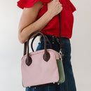 Updated handles, a refreshed crossbody strap with custom lining, printed in South Africa. 