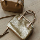 A limited-edition bag with only 10 pieces made. This exclusive design features exotic Nguni hair-on leather with delicate metallic gold splashes, beautifully complemented by a caramel leather back, bottom and sides.