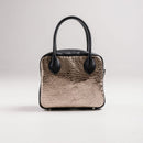 A limited-edition bag with only 10 pieces made. This exclusive design features exotic Nguni hair-on leather with delicate metallic gold splashes, beautifully complemented by a caramel leather back, bottom and sides.