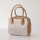 A limited-edition bag with only 10 pieces made. This exclusive design features exotic Nguni hair-on leather with delicate metallic gold splashes, beautifully complemented by a caramel leather back, bottom and sides.