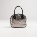 A limited-edition bag with only 10 pieces made. This exclusive design features exotic Nguni hair-on leather with delicate metallic gold splashes, beautifully complemented by a caramel leather back, bottom and sides.