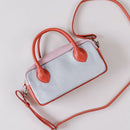 Lighter, softer and with easy handles and a crossbody strap.  Meet the all new MINI POSTCALL.