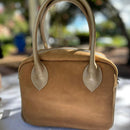Updated handles, a refreshed crossbody strap with custom lining, printed in South Africa. 