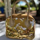 Updated handles, a refreshed crossbody strap with custom lining, printed in South Africa. 